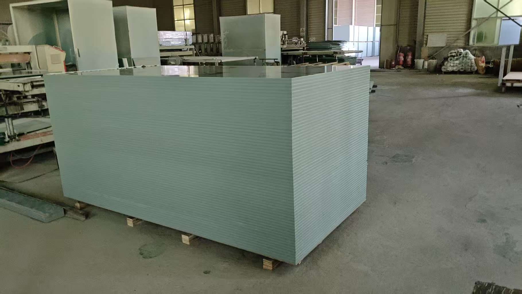 PVC plastic concrete formwork factory exterior with loading trucks and production facilities