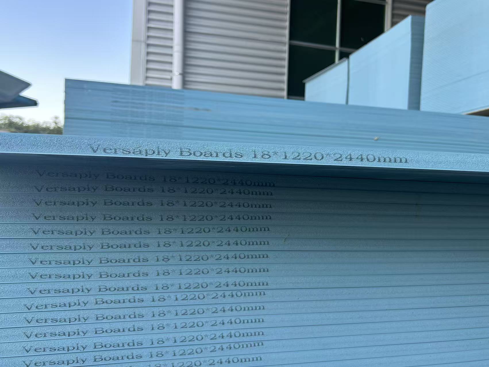 Smooth blue PVC plastic concrete formwork panels stacked showing reflective surface quality